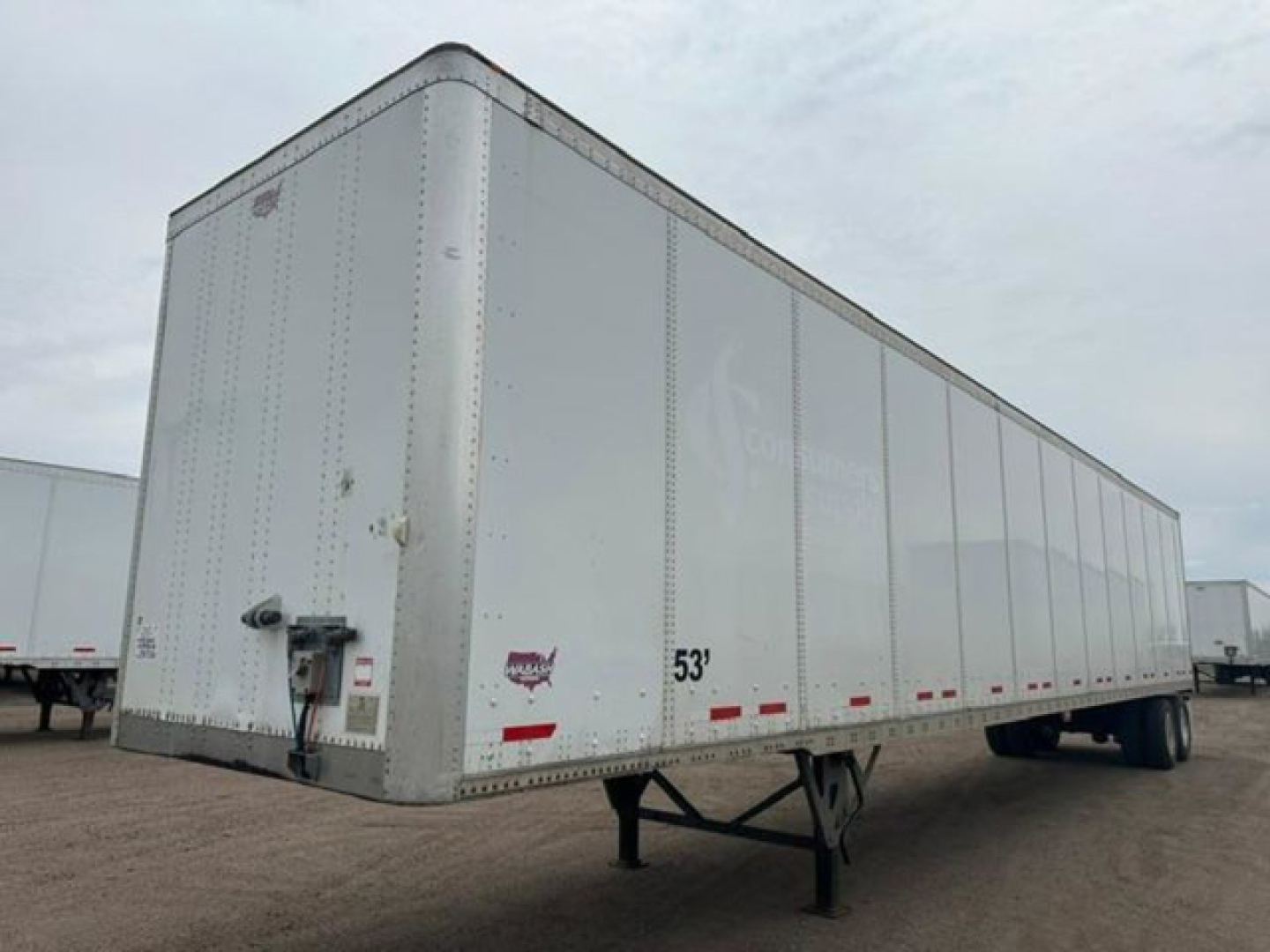 Trailer side and front showing a 53' aluminum dry van with nose rail, DOT reflectors, and landing gear visible.