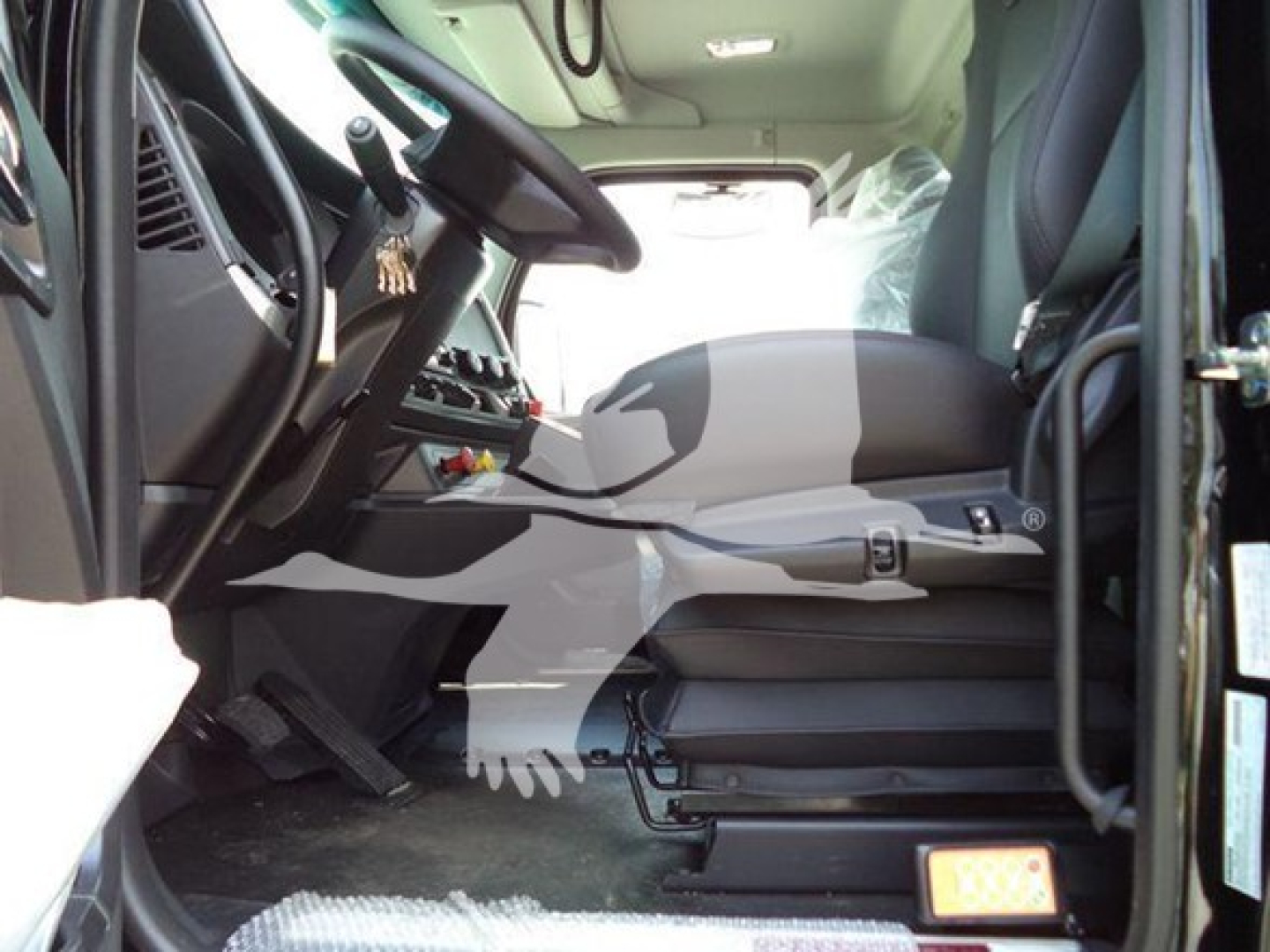 Kenworth T880 truck cab interior view showing steering wheel, driver's seat, and dashboard with controls.