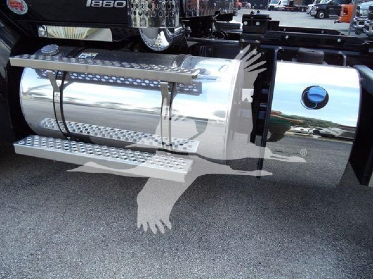 Kenworth T880 truck side exhaust and chrome fuel tank with chrome steps and perforated grips.