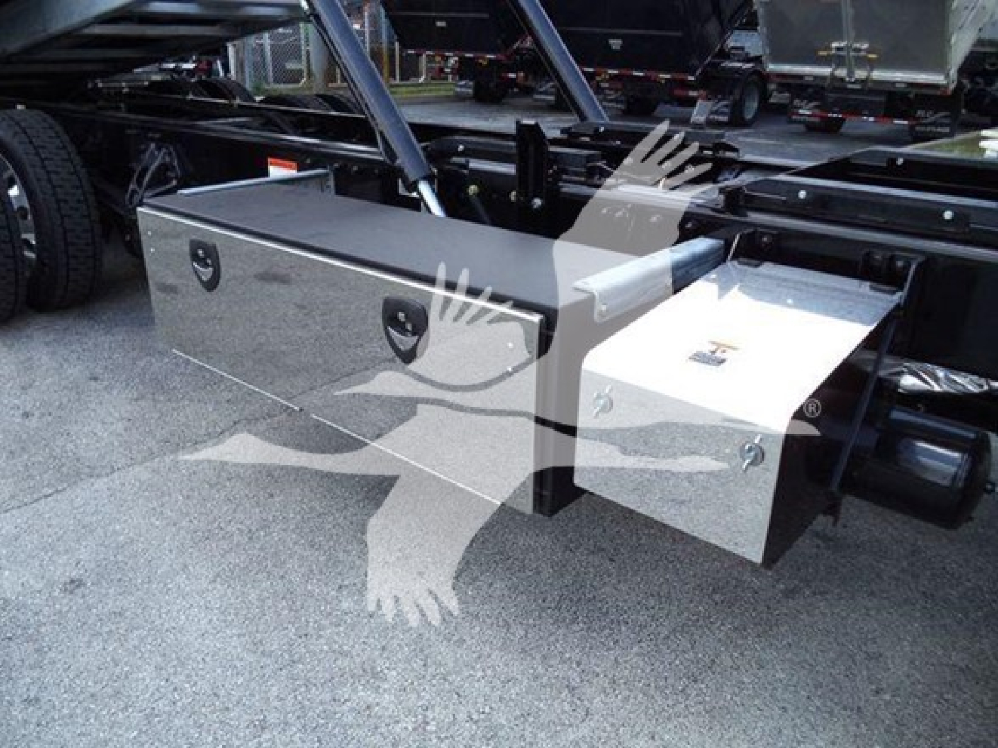 Kenworth T880 rollback chassis showing aluminum toolboxes mounted under the frame with locks and latches.
