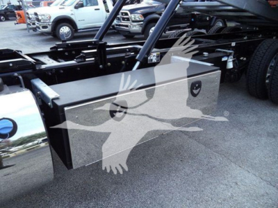 Kenworth T880 rollback chassis with a large rectangular metal toolbox mounted near the frame, side view showing storage box and chassis components.