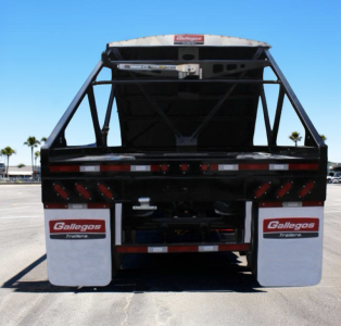 Back view of a Gallegos Sand Hopper trailer showing rear platform, black frame, and white Gallegos mudflaps with red Gallegos Trailer logos.