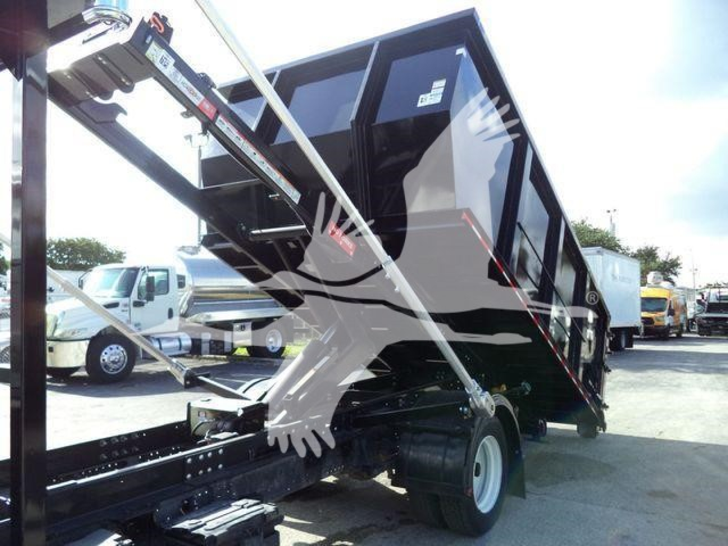 Isuzu NPR truck dump bed/dump body rollover configuration showing hydraulic lifting mechanism and dual-cab chassis.