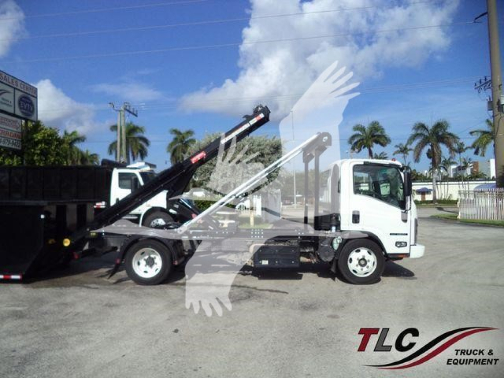 Isuzu NPR medium-duty truck with roll-off hoist in service view, white cab and black bed, palm trees in background, TLc Truck & Equipment logo watermark.