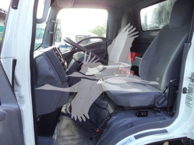 Isuzu NPR or similar cab interior showing driver and passenger seats, steering wheel, and dashboard