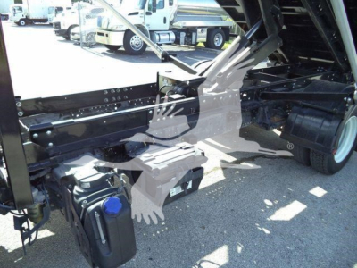 Isuzu NPR/NRR truck chassis and underbody showing hydraulic system and fuel container with blue cap near side, rear wheel, and roll-off bed linkage.