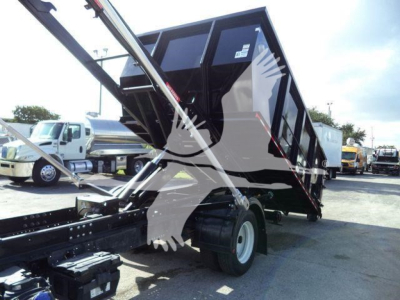 Isuzu NPR/NRR dump truck tilt bed in-service with raised dump bed and hydraulic arms visible; no legible text or stickers readable on the machinery in this view.