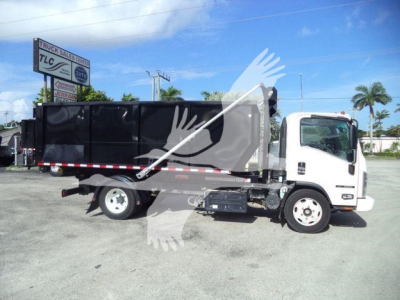 Isuzu NPR/NRR dump truck in side view showing cargo bed and cab with black dump body