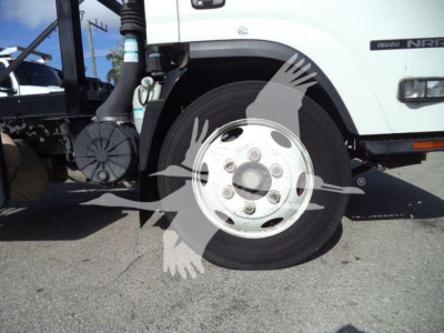 Isuzu NPR truck wheel and front fender view showing front hub and tire.