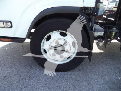 Isuzu NPR roll-off truck front wheel and fender visible, white cab, steel wheel with tire, visible part of chassis and side mirror.