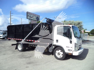 Isuzu NPR/NRR roll-off truck in-service showing cab and black dump body with hydraulic lift, side marker lights, front grille, and wheel wells.