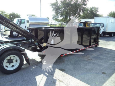 Isuzu NPRR roll-off truck in service bed with hydraulic arm and black dump body, side view showing cargo container and chassis.