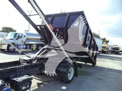 Isuzu NPR or NRR roll-off truck bed in raised position showing hydraulic arms and rear cab enclosure.