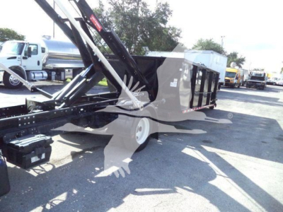 Isuzu NRR roll-off truck body with hydraulic crane arm visible, side view showing dumpster bed and support frame.