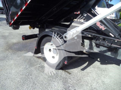 Isuzu NPRR roll-off truck rear wheel and hydraulic tilt bed components with white steel wheel and black chassis.