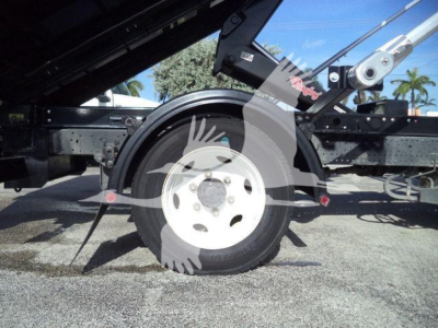 Isuzu NPR/NRR truck chassis with wheel and hydraulic system components visible, wheel hub and tire, frame rails, and hydraulic support arm.