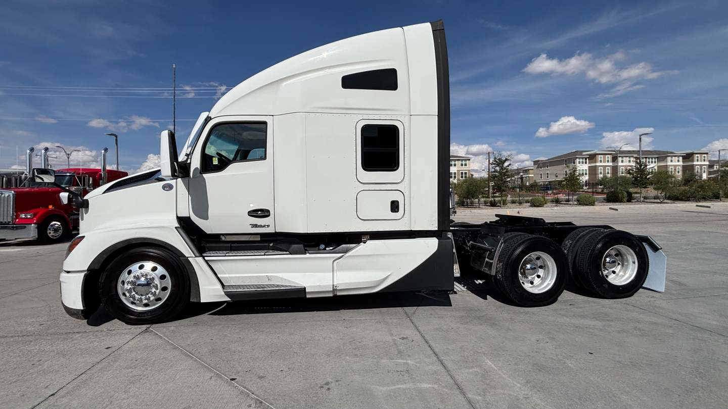 Kenworth T680 tractor-side view showing sleeper cab and rear wheels with chrome rims; VIN tag and stock number not visible
