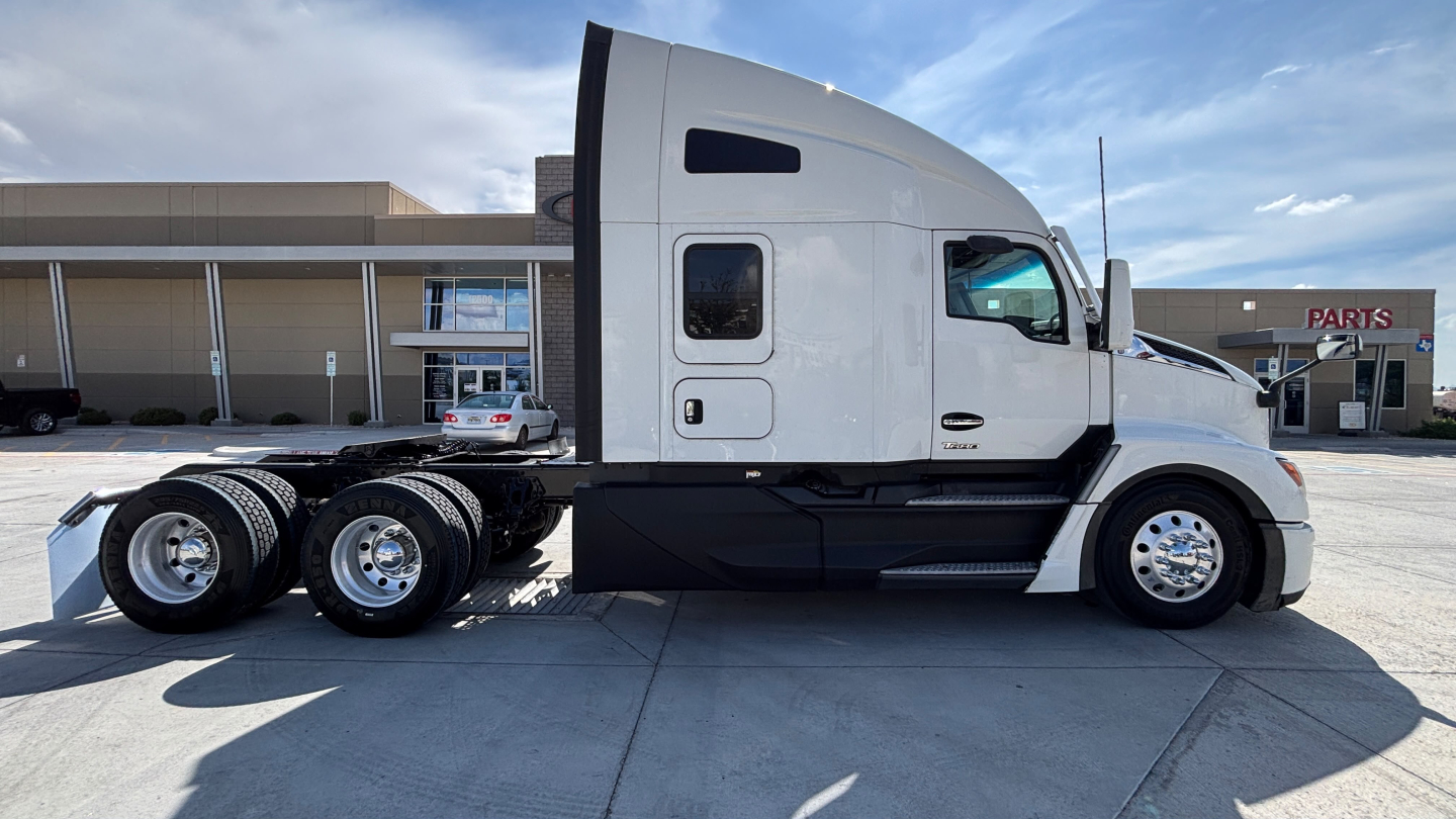 Kenworth T680 truck side view showing sleeper cab and rear axles.