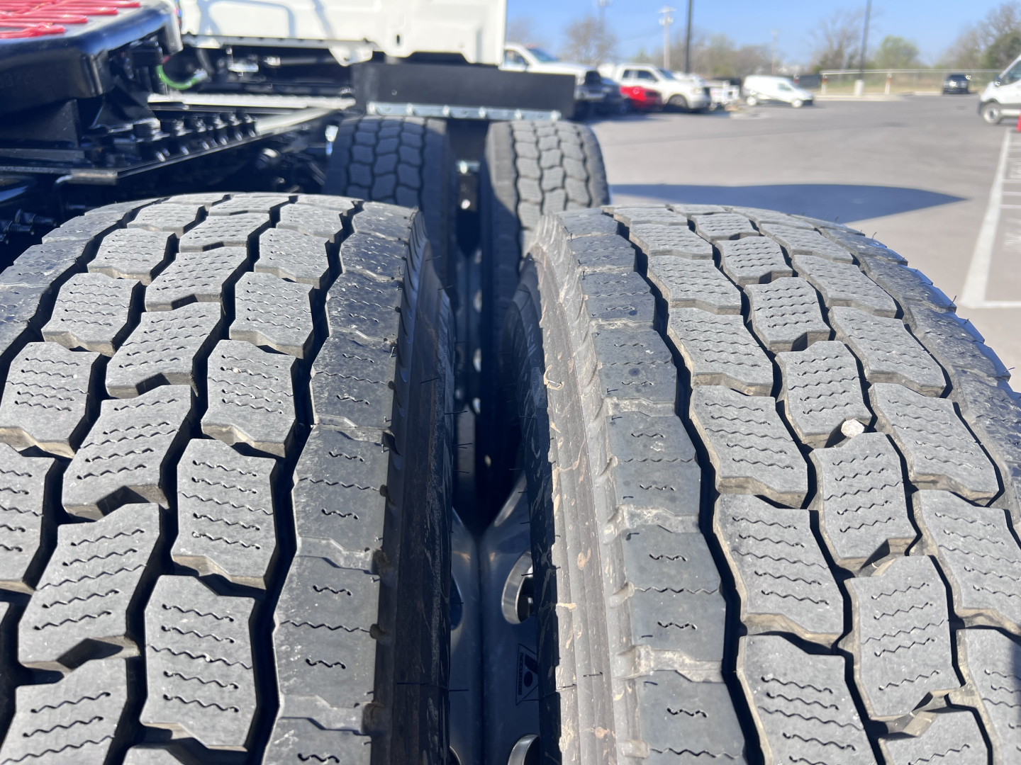 Twin rear truck tires on a Mack AN64T tractor showing tread pattern and wheel wells.