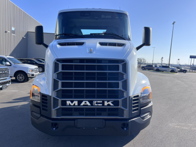 Front view of a white 2027 Mack AN64T conventional daycab truck showing large black grille, Mack lettering, dual hood scoops, and rectangular headlights.