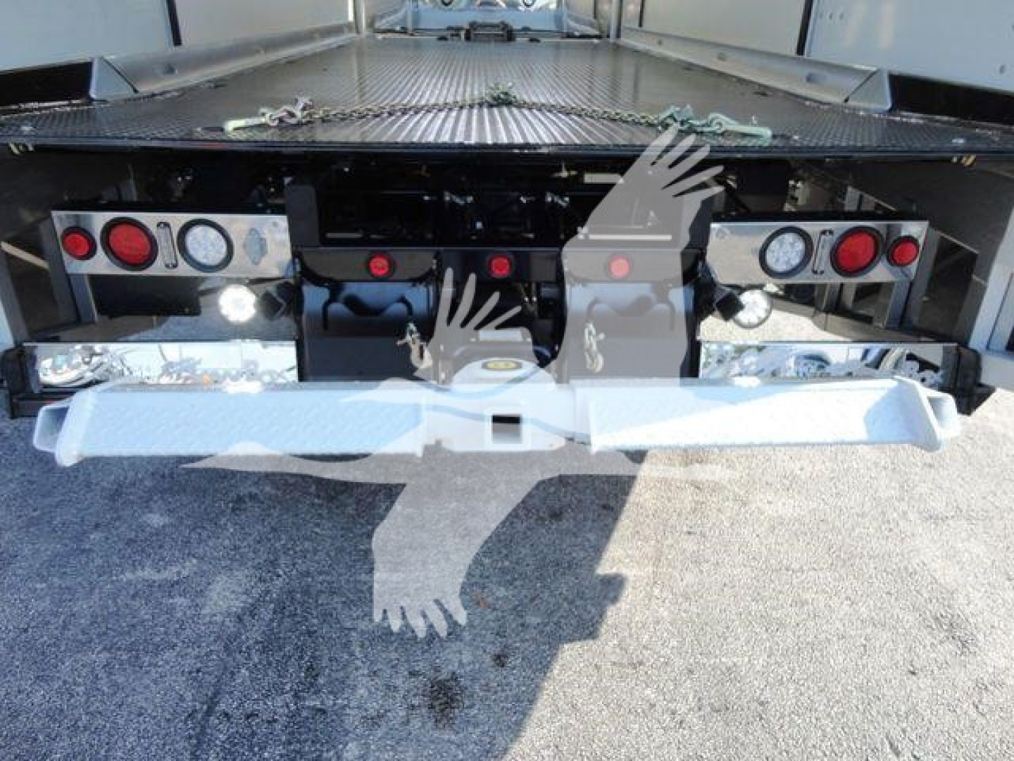 Rear view of a 2022 International MV rollback truck showing taillights, bumper, and platform with loading area