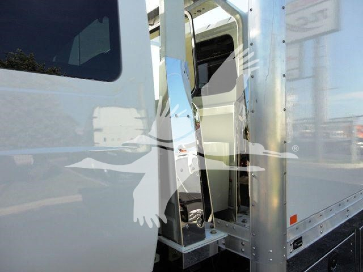 Truck cab with open door showing interior steps and window reflection. No visible text on the image.
