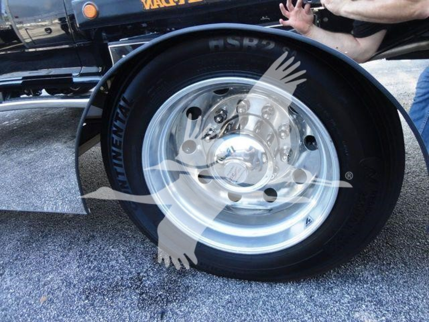 Truck wheel and tire close-up showing steel rim and black tire with Continental brand text on sidewall.