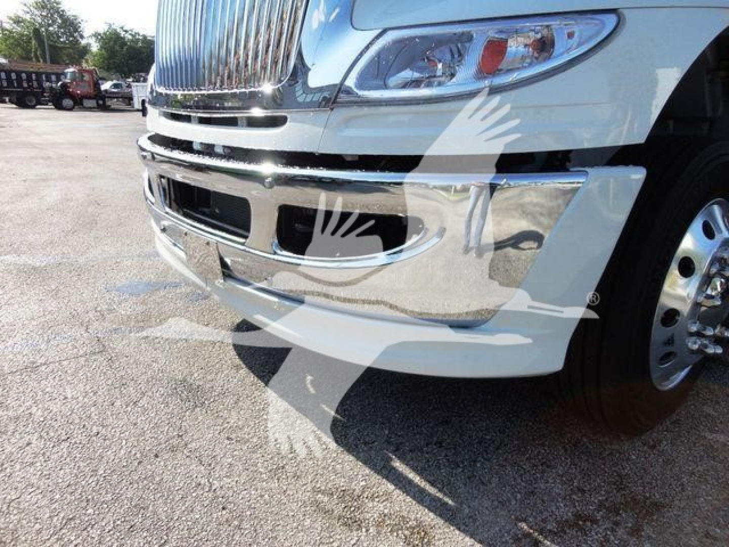 Front right view of a 2022 International MV truck showing chrome bumper, grille, headlight, and part of front wheel.