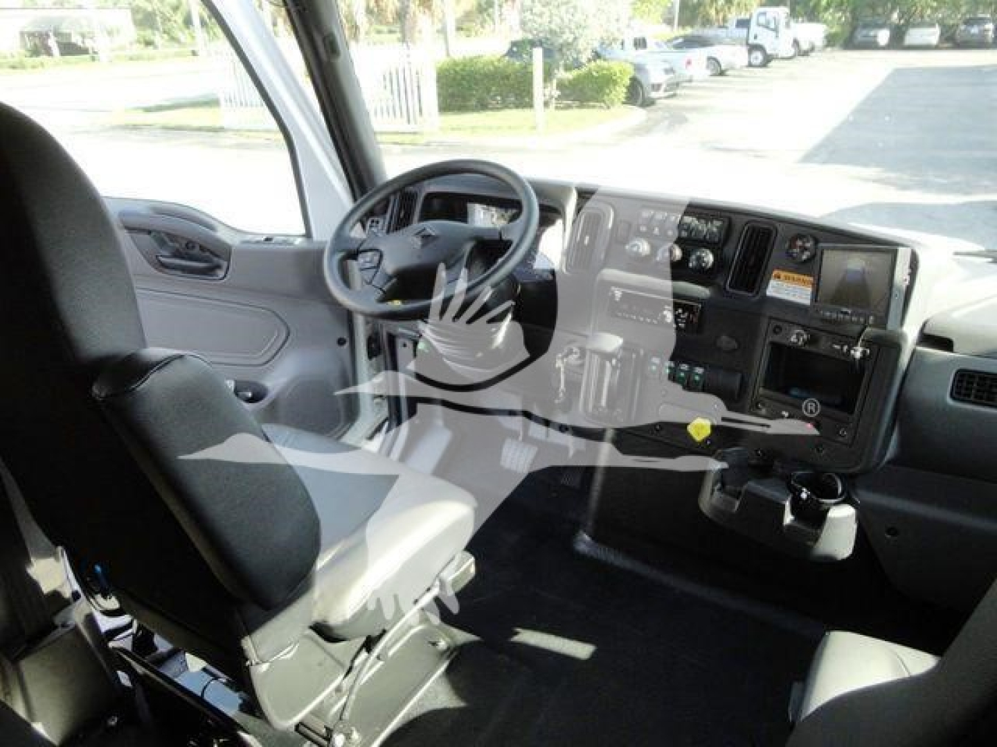Interior cab of a 2022 International MV rollback truck showing steering wheel, dashboard with gauges, and driver seat