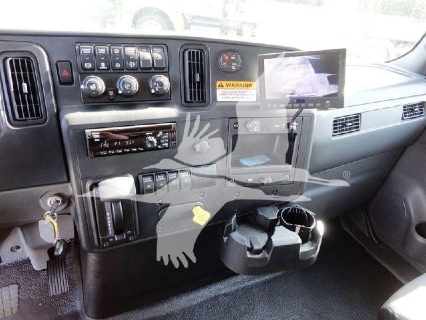 Interior dashboard of a 2022 International MV truck showing steering column, control panel, cup holders, and climate controls.