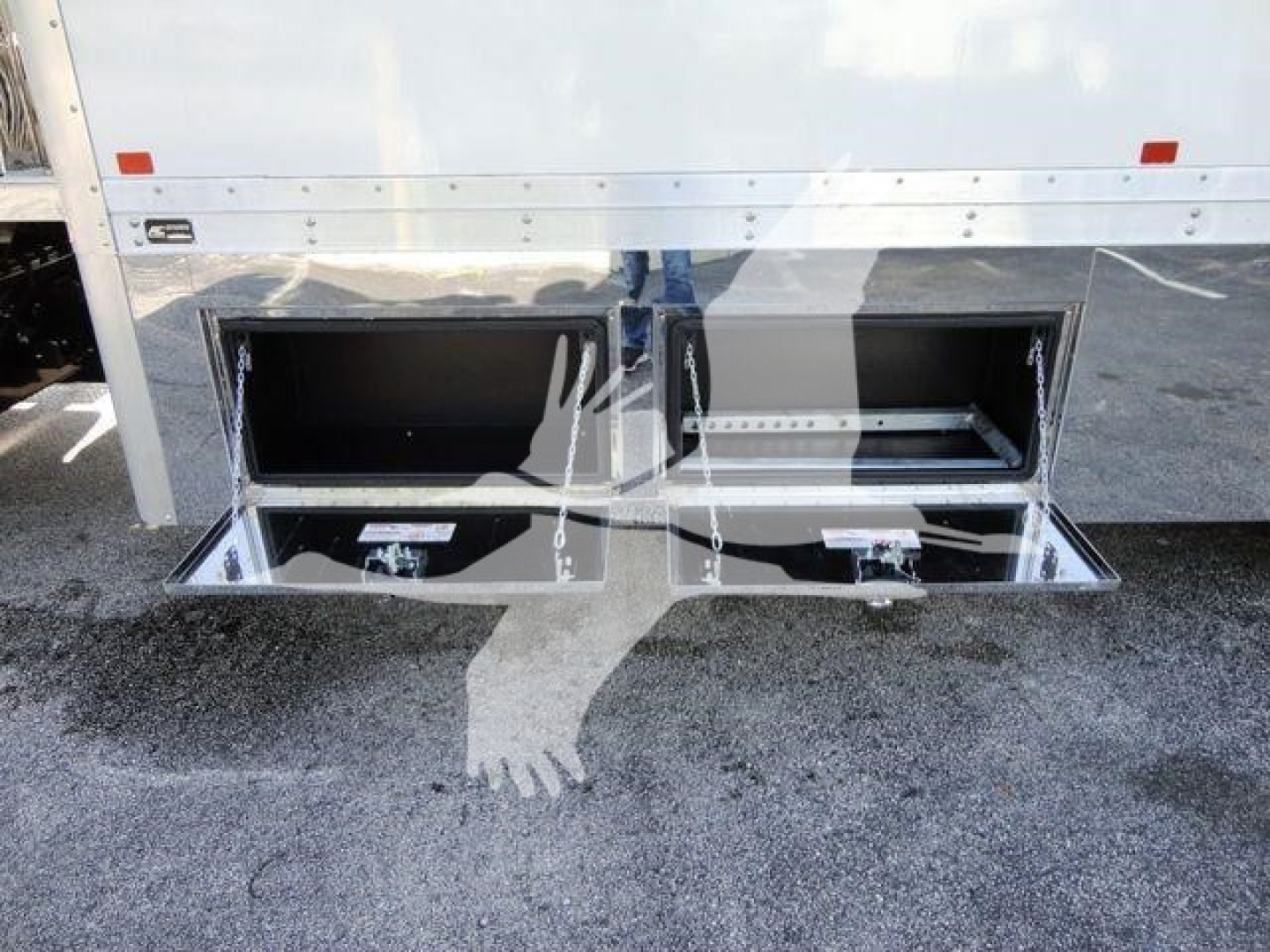 Trucks rear underbody storage compartments open showing two slide-out trays in a 2022 International MV rollback truck.