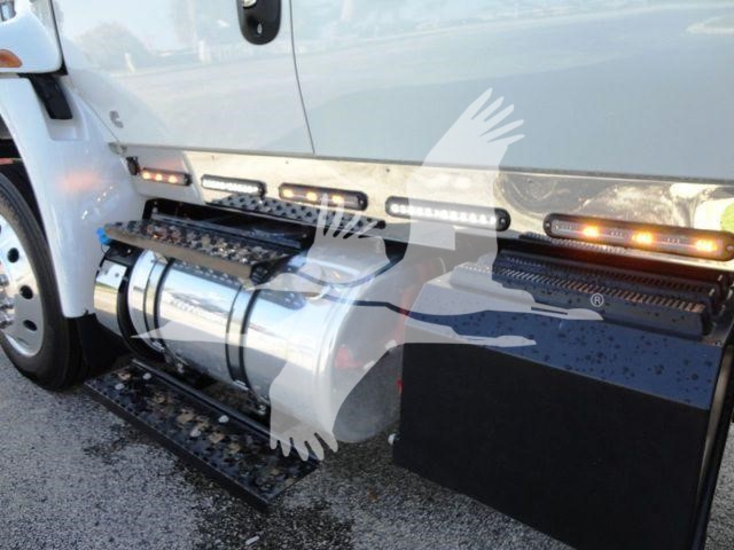Truck side step and fuel tank with brand markings visible on a 2022 International MV rollback truck.