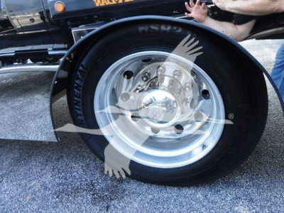 Truck wheel and tire close-up showing steel rim and black tire with Continental brand text on sidewall.