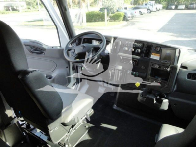 Interior cab of a 2022 International MV rollback truck showing steering wheel, dashboard with gauges, and driver seat