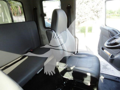 Truck cab interior showing front bench seat and passenger seat with steering wheel to the right and door panel