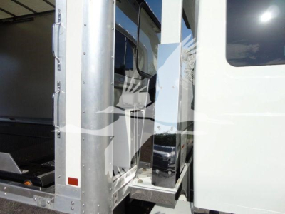 Truck cab and step area of a 2022 International MV rollback truck showing entry step and door frame.