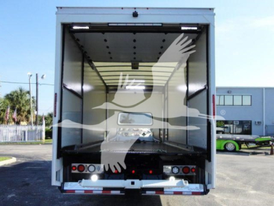 Truck trailer back view showing empty cargo area with open liftgate, rear lights, and reflective bumper.