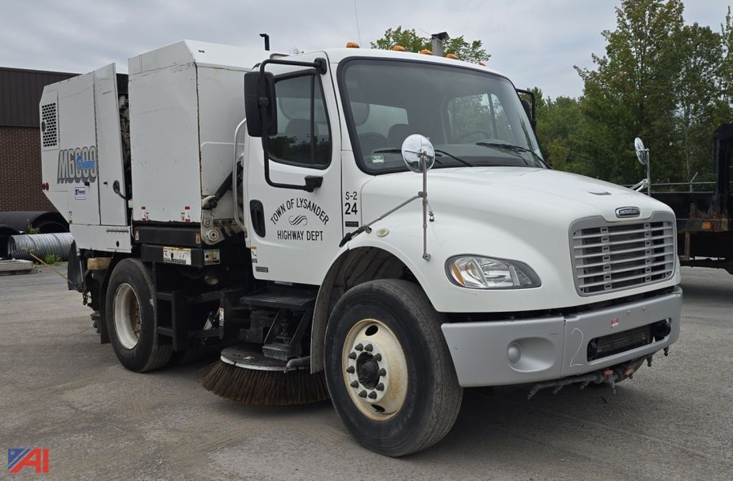 Fleet Sweeper truck 2007 Freightliner M2 106 in-service with auxiliary equipment mounted in rear; front grille, dual mirrors, bumper, and large brush under carriage visible.
