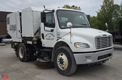 Fleet Sweeper truck 2007 Freightliner M2 106 in-service with auxiliary equipment mounted in rear; front grille, dual mirrors, bumper, and large brush under carriage visible.