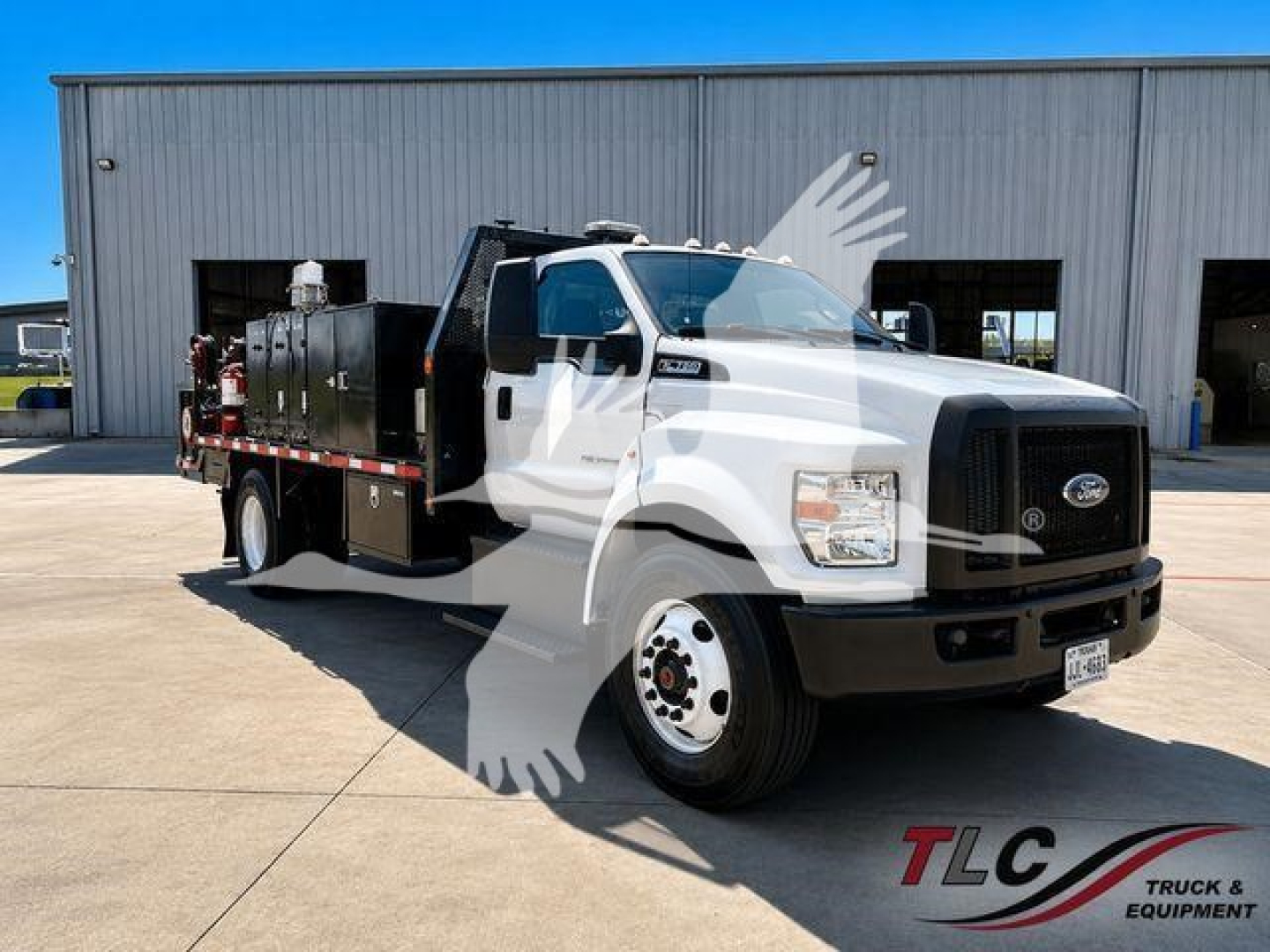 Ford F-750 XL SD truck with service body and equipment on site