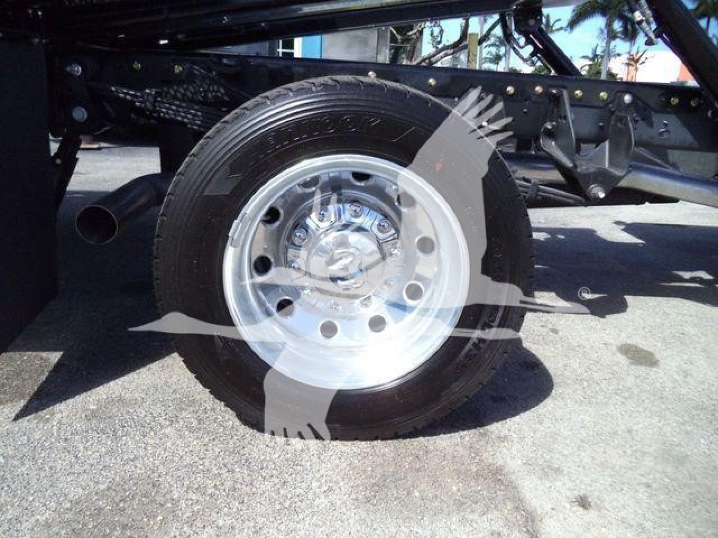Ram 5500 Rollback truck wheel close-up showing steel rim and tire with undercarriage frame in background.