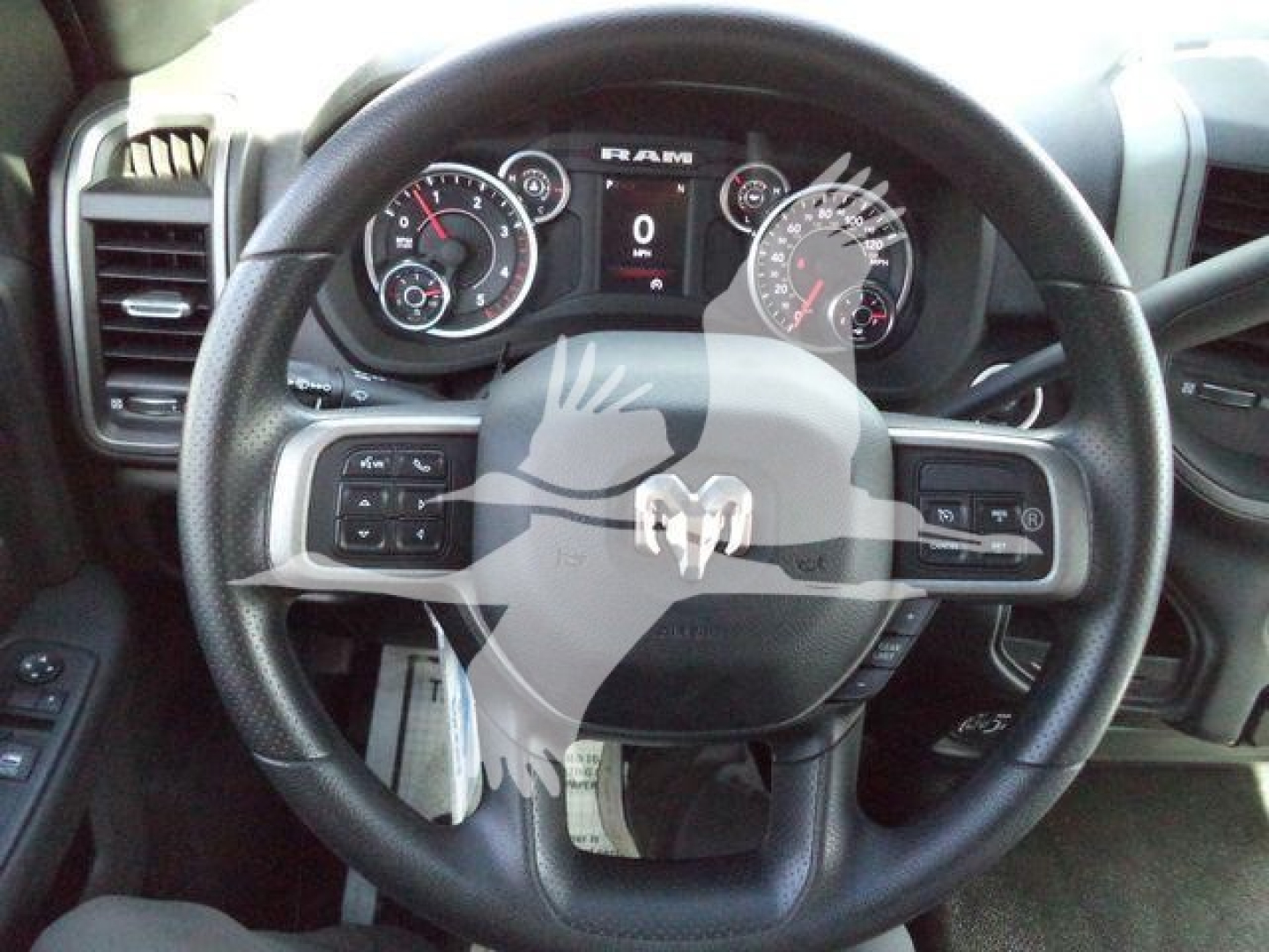 Ram 5500 steering wheel and instrument cluster in view; dashboard displays RAM logo and gauge dials through wheel.
