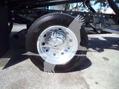 Ram 5500 Rollback truck wheel close-up showing steel rim and tire with undercarriage frame in background.