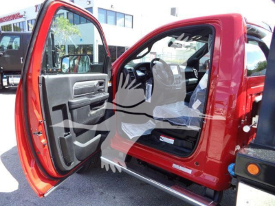 Ram 5500 SLT cab interior with front door open, red exterior, showing driver seat and dashboard from outside.