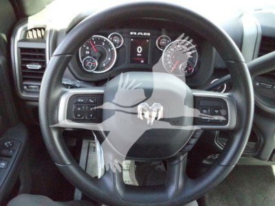 Ram 5500 steering wheel and instrument cluster in view; dashboard displays RAM logo and gauge dials through wheel.