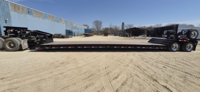 Lowboy trailer showing 48-foot extendable hyd_detach double drop with dual rear axles and extendable deck.