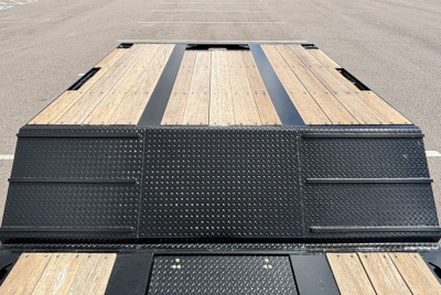 Lowboy trailer deck with wood planks and diamond plate steel, extendable hyd detach double drop, rear view showing deck and ramp sections.