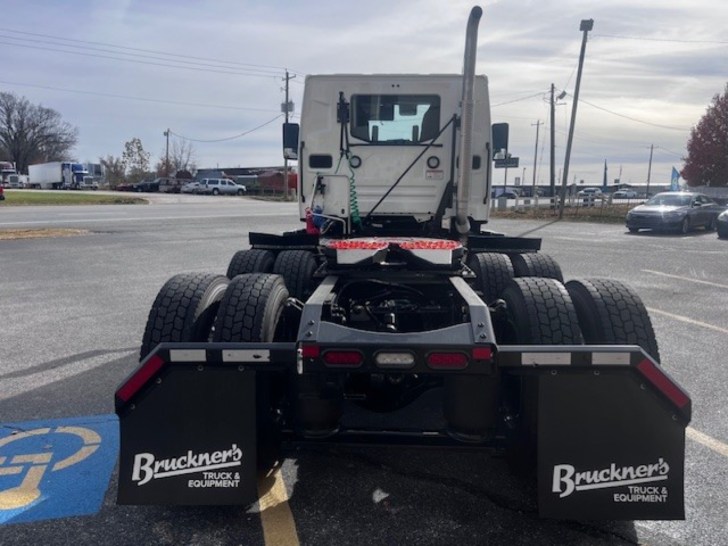 Mack PR64T tractor (cab and rear) showing rear chassis, dual rear axles, and mud flaps with Bruckner's Truck & Equipment logos.