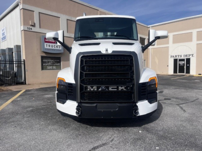 Front view of a white Mack PR64T truck in dealership lot showing bold grille and headlights.