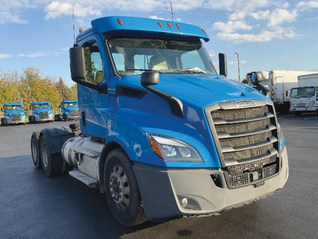 Freightliner Cascadia 116 truck cab front-left view with blue body and gray bumper.